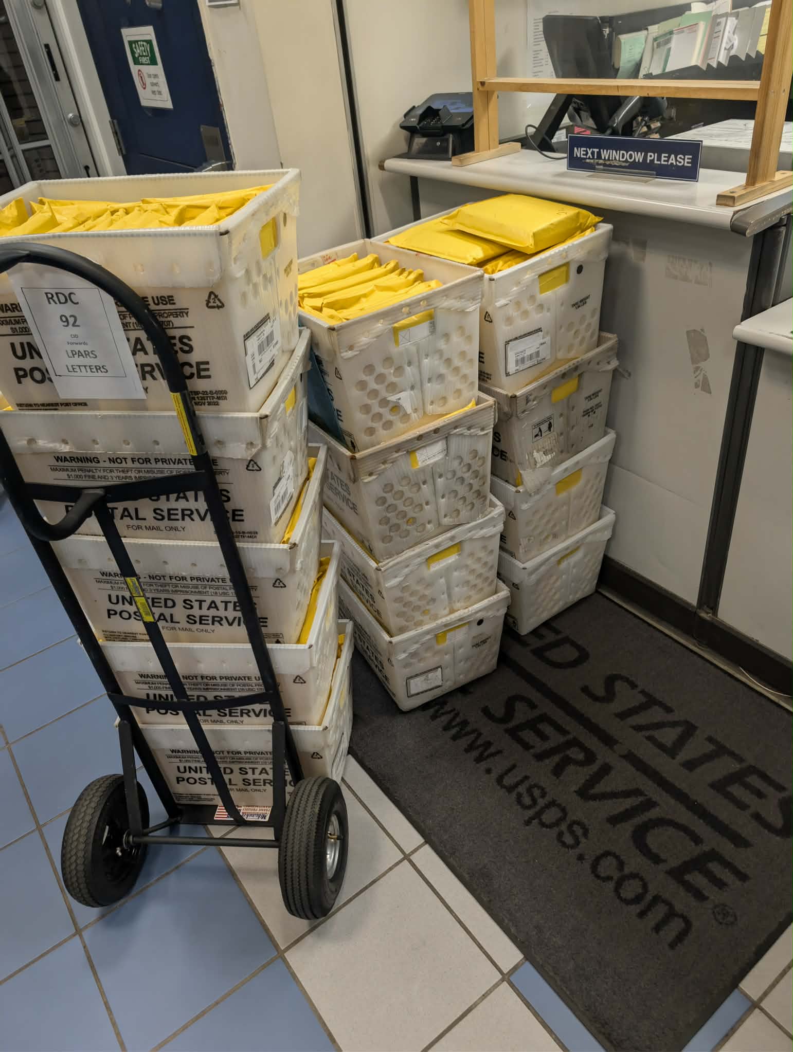 Bins of books at the post office ready to ship